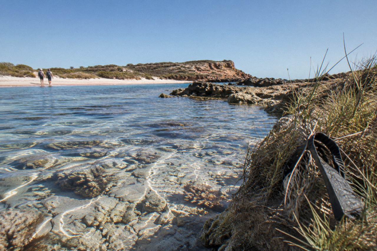 Clear shallow water over a coral reef with sunlight on the sea floor
