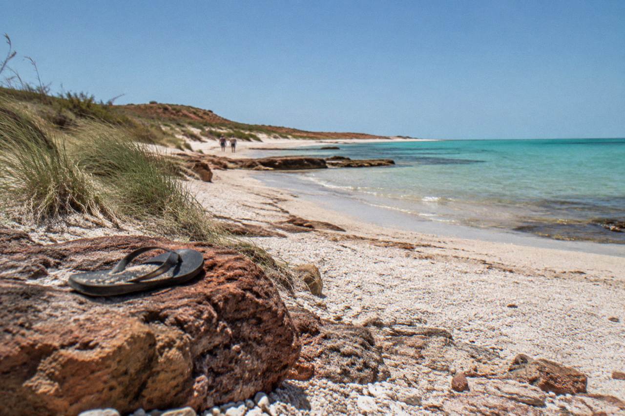 Calm sandy beach at Exmouth with turquoise shallows along the Ningaloo reef shoreline