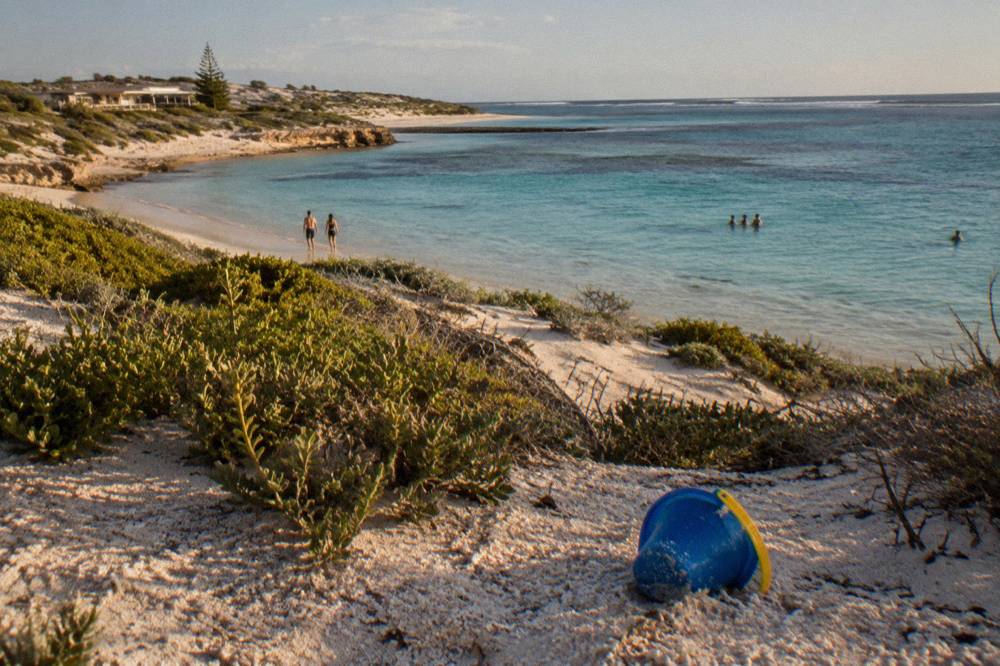 The shallow turquoise lagoon at Coral Bay where the reef starts close to the sand