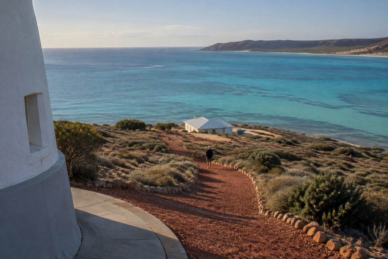 Turquoise calm water over coral reef near Exmouth with distant low hills