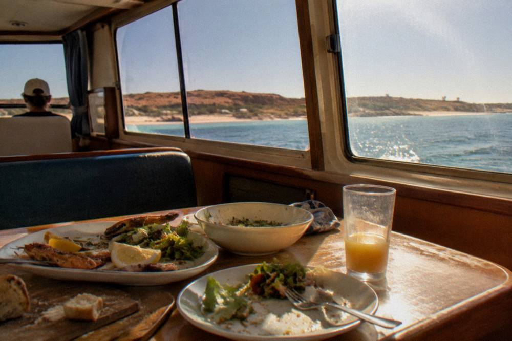 A boat cabin table set with lunch platters on the homeward run